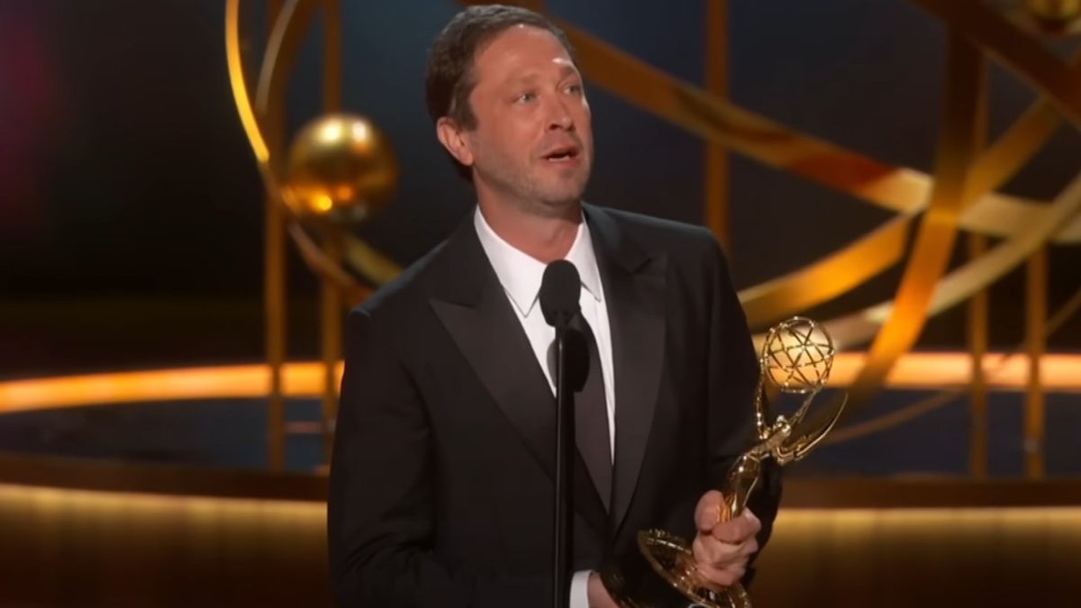 A screenshot of Ebon Moss-Bacrach holding his Emmy giving a speech at the 75th Emmy Awards.