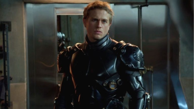 Charlie Hunnam stands dressed in his jaeger suit in Pacific Rim.