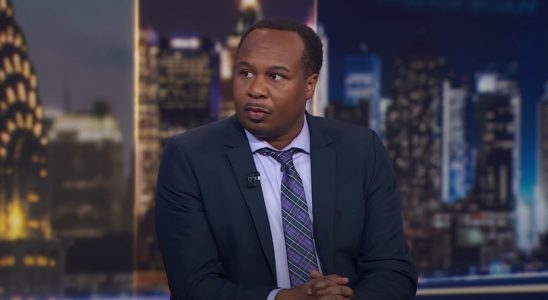 Roy Wood Jr. sitting at the main desk on The Daily Show.