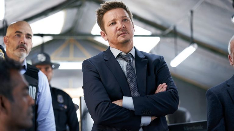 Jeremy Renner standing with his arms crossed in Mayor of Kingstown