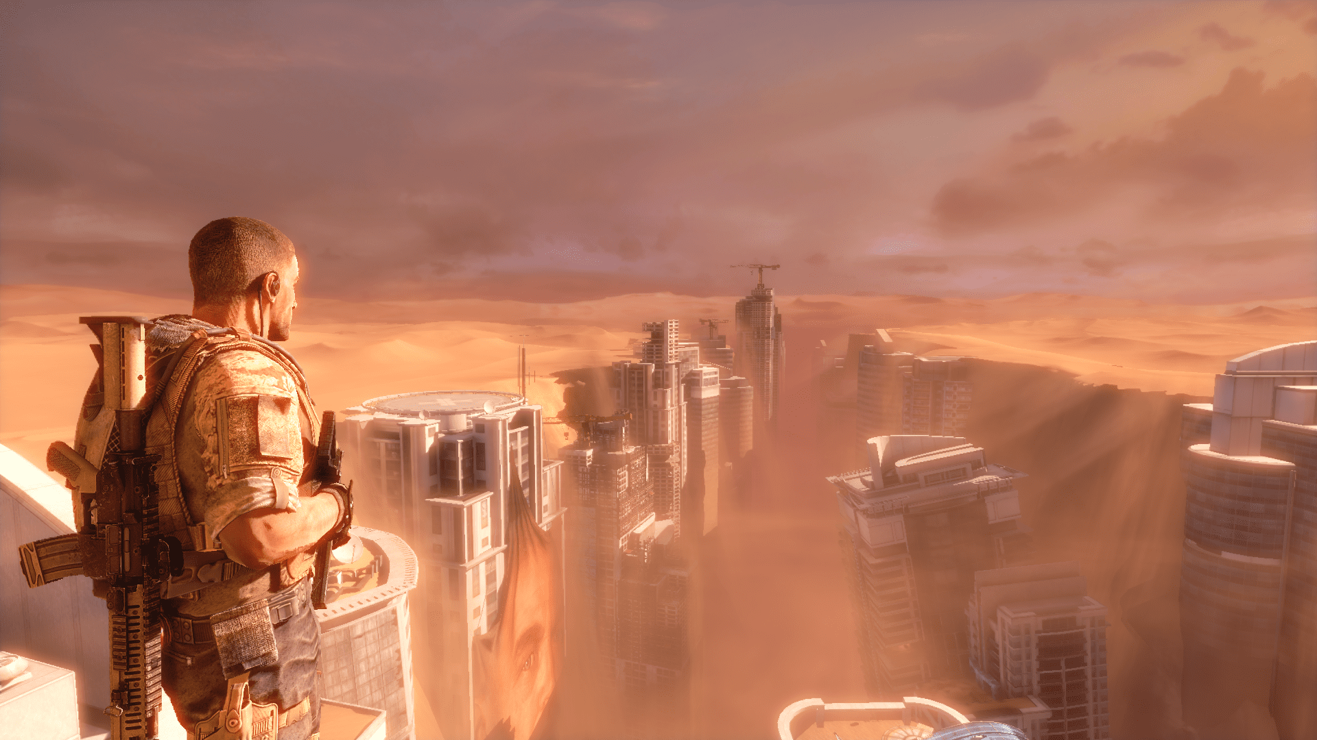 A soldier looks over a sand-blasted city in a screenshot from Spec Ops: The Line.