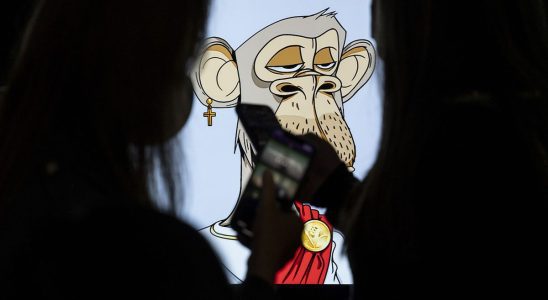 HONG KONG, CHINA - OCTOBER 22: Visitors take a photo of the NFT (non-fungible token) artwork known as