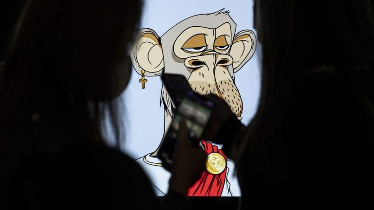 HONG KONG, CHINA - OCTOBER 22: Visitors take a photo of the NFT (non-fungible token) artwork known as 