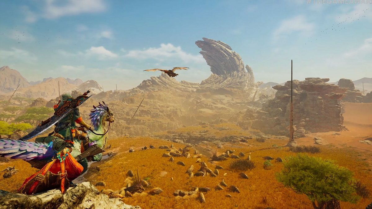 Image of a traveler in monster-like armor riding a bird creature through a rocky desert in Monster Hunter Wilds.