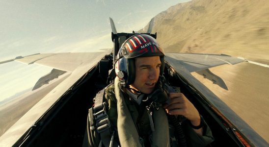 Tom Cruise talking into the radio in an airplane during Top Gun: Maverick.