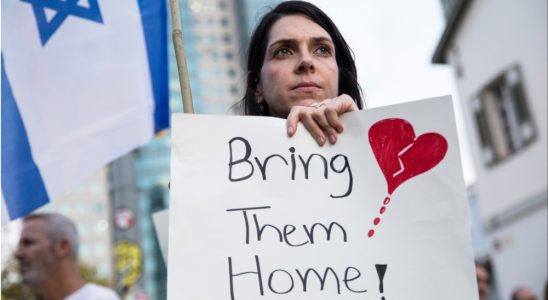 A woman holds a sign during a protest calling to bring back the hostages that were kidnaped last Saturday during Hamas' and Palestinan terrorists attack