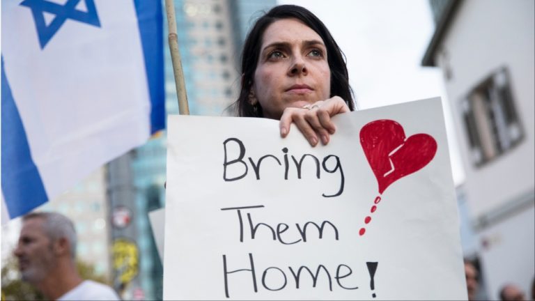 A woman holds a sign during a protest calling to bring back the hostages that were kidnaped last Saturday during Hamas' and Palestinan terrorists attack