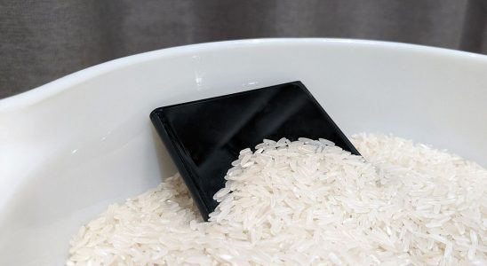 A smartphone sitting in rice