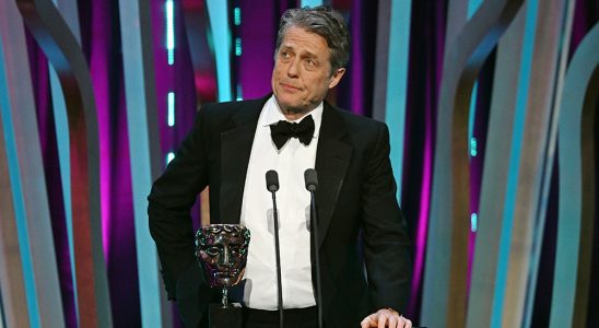 LONDON, ENGLAND - FEBRUARY 18: Hugh Grant presents the Director Award on stage during the EE BAFTA Film Awards 2024 at The Royal Festival Hall on February 18, 2024 in London, England. (Photo by Kate Green/BAFTA/Getty Images for BAFTA)