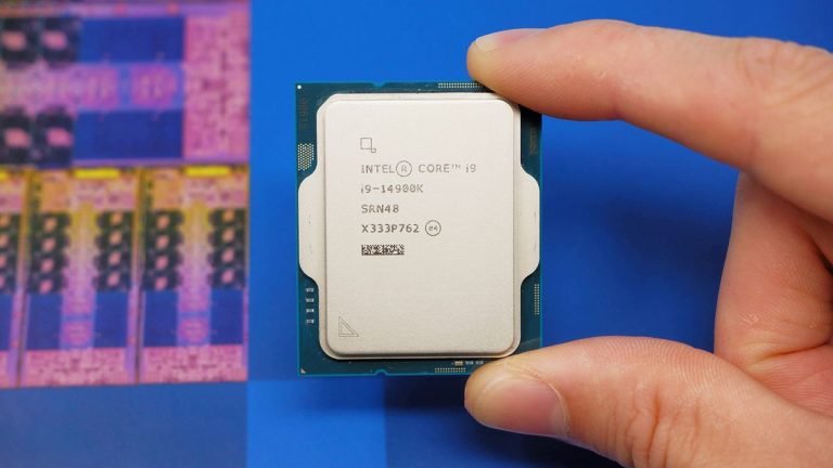 Intel Core i9 14900K CPU on a box and inside a motherboard socket.