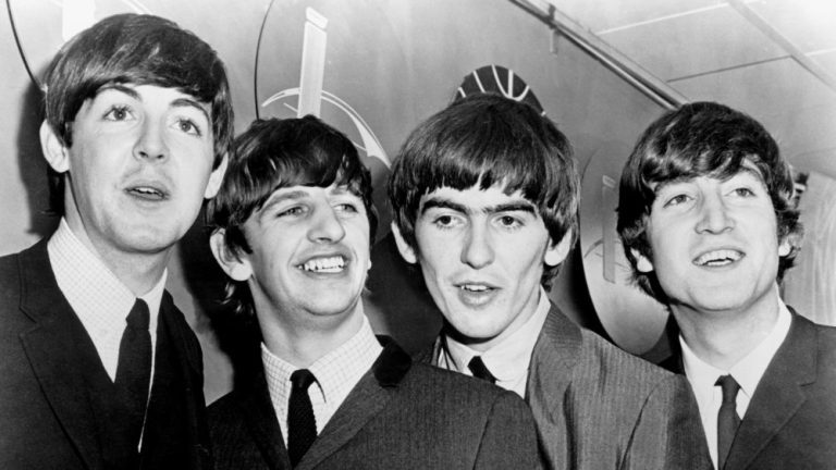 BEATLES, THE: Paul McCartney, Ringo Starr, George Harrison, John Lennon, being interviewed at the airport, during their first US tour in February, 1964.