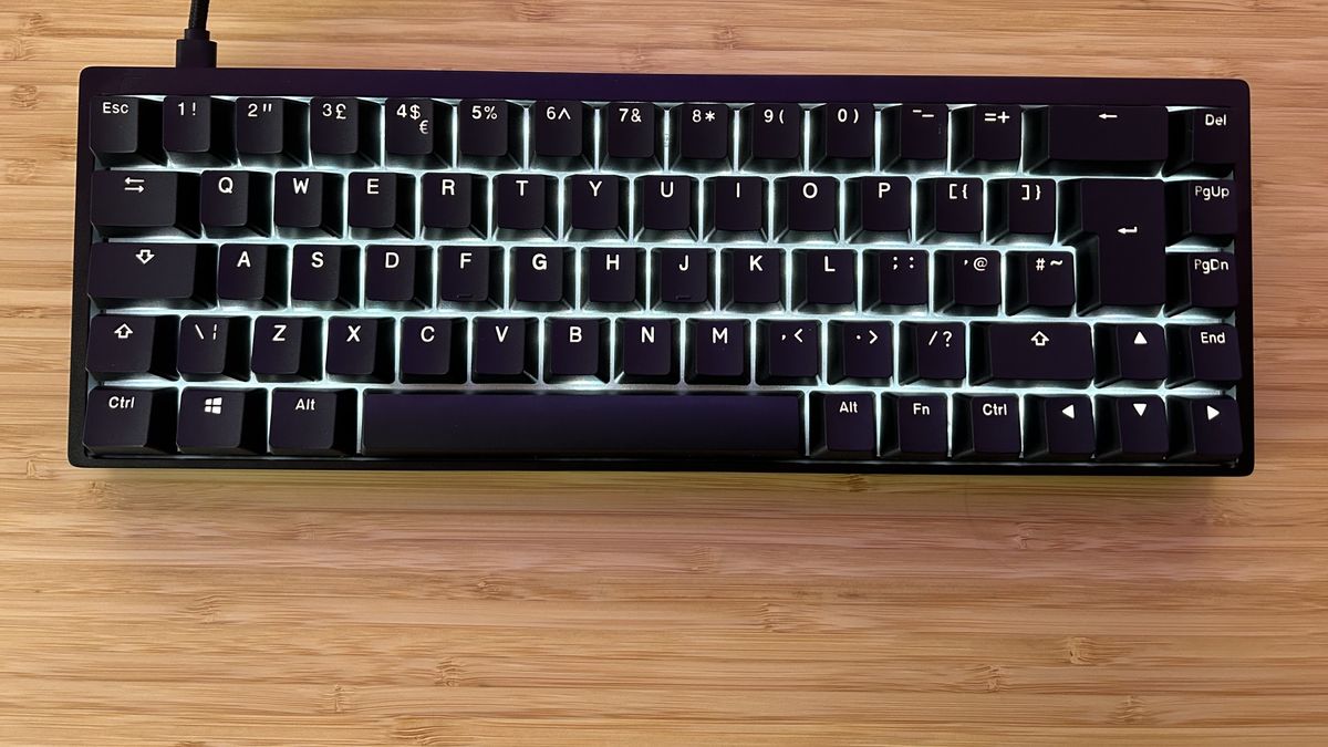 Endgame Gear KB65HE with RGB lighting on sitting on a wooden desk