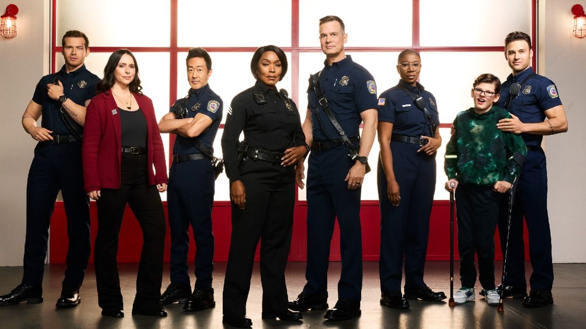 From L to R: Oliver Stark, Jennifer Love Hewitt, Kenneth Choi, Angela Bassett, Peter Krause, Aisha Hinds, Gavin McHugh, and Ryan Guzman pose for 9-1-1 Season 7.