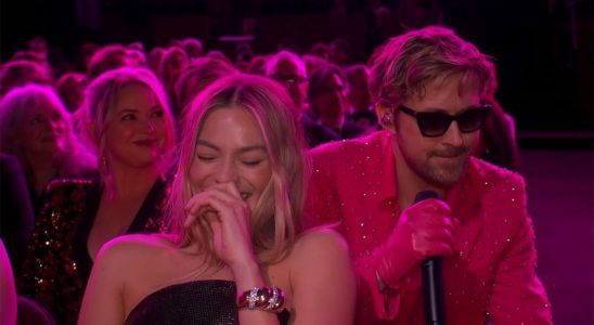 Margot Robbie laughing while Ryan Gosling performs "I