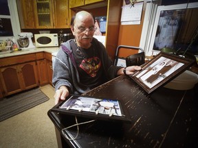 Eddy Ambrose, un Manitobain changé à la naissance, regarde des photos des parents qui l'ont élevé, James et Katherine Ambrose, et de ses parents biologiques, Laurette et Camille Beauvais, à son domicile de Winnipeg, le lundi 13 février 2023. Ambrose et Richard Beauvais doivent recevoir des excuses du gouvernement du Manitoba.