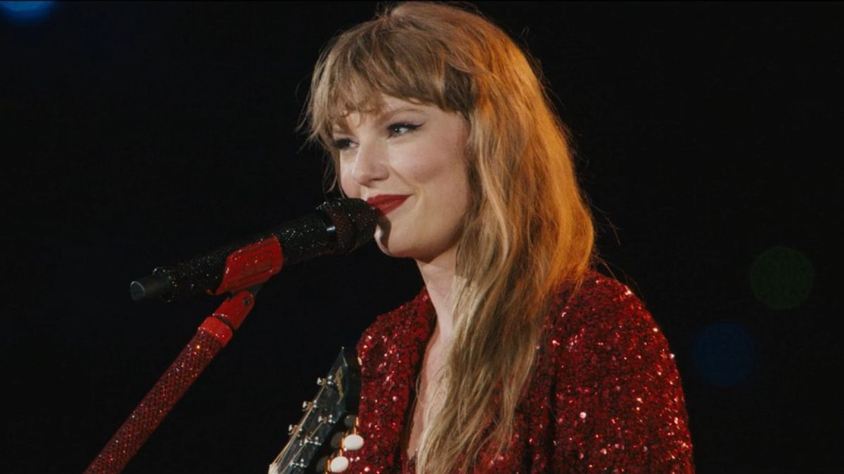 A screenshot of Taylor Swift smiling while singing All Too Well during the Eras Tour.