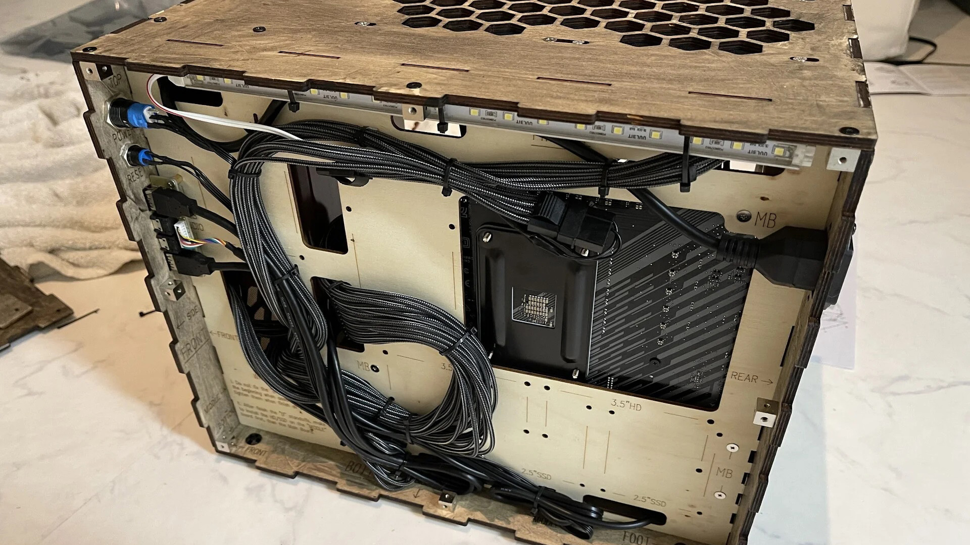 Le passe-câbles du PC gamer en bois Noctua