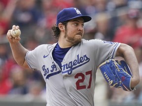 DOSSIER – Le lanceur partant des Dodgers de Los Angeles, Trevor Bauer (27 ans), livre lors de la première manche d'un match de baseball contre les Braves d'Atlanta, le dimanche 6 juin 2021, à Atlanta.  Bauer a déclaré lundi 18 mars 2024 qu'il lancerait pour l'équipe mexicaine des Diablos Rojos lors de leur match hors-concours de dimanche contre les Yankees de New York alors que le lauréat du NL Cy Young Award 2020 tente de revenir dans les majors pour la première fois en trois ans. .