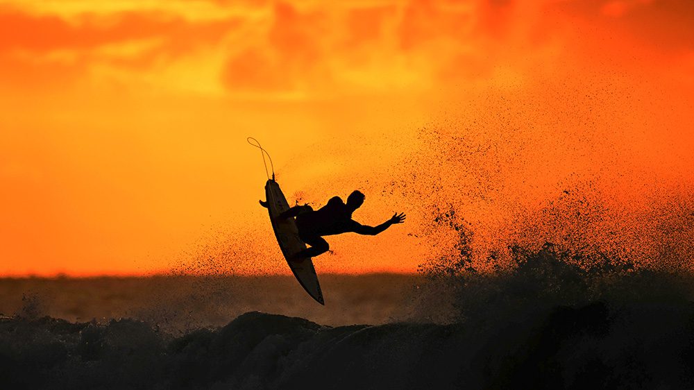 BELLS BEACH, AUSTRALIA - MARCH 27: A surfer warms up at sunrise ahead of the 2024 Rip Curl Pro Bells Beach on March 27, 2024 in Winkipop, Australia.  (Photo by Morgan Hancock/Getty Images)