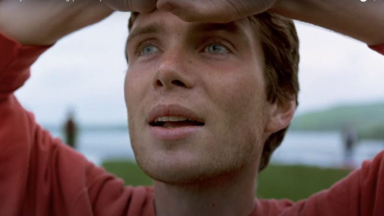 Cillian Murphy looks up to the sky smiling in 28 Days Later.