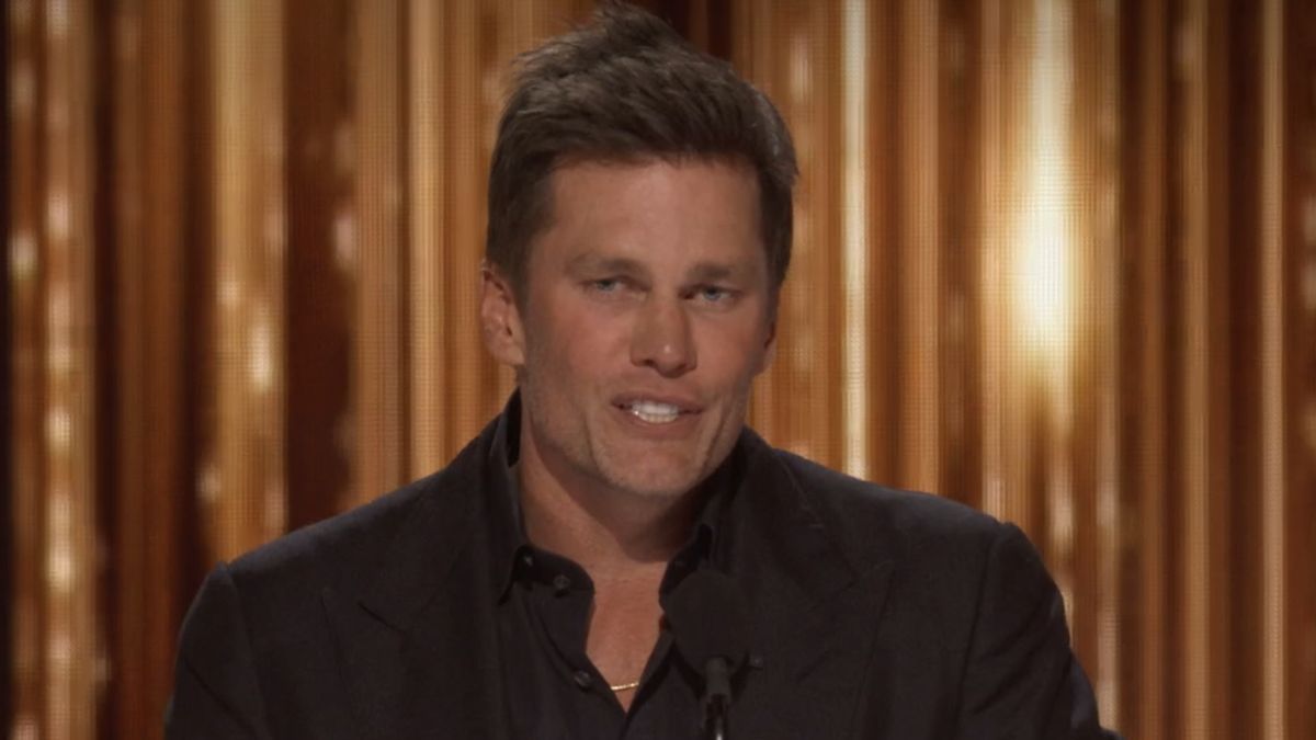 Tom Brady on stage telling jokes at The Roast of Tom Brady