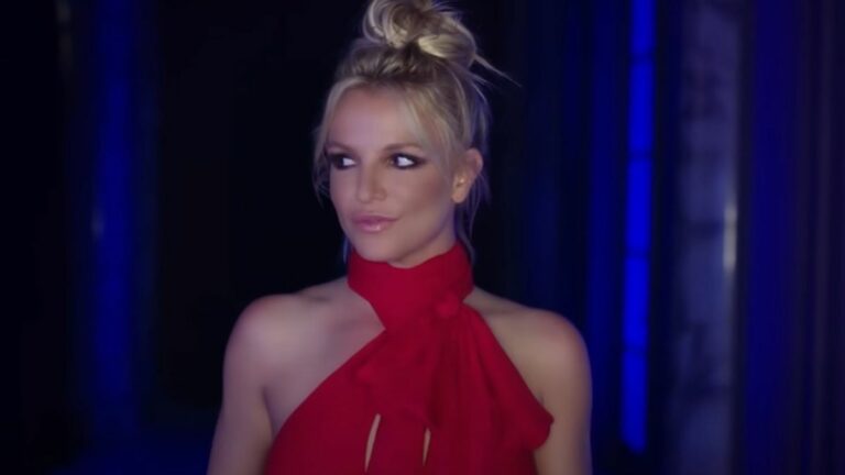 Britney Spears looking to her left in the Slumber Party music video.