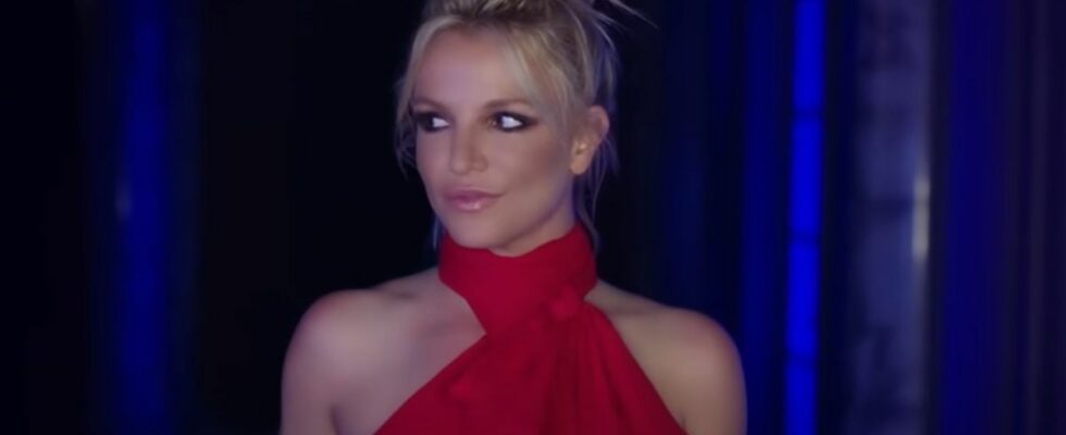 Britney Spears looking to her left in the Slumber Party music video.