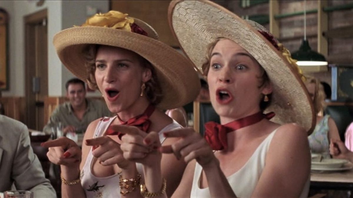 Rachel Griffiths and Carrie Preston wear large hats as they sing "I Say a Little Prayer" in My Best Friend