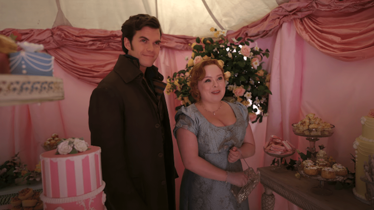 Colin Bridgerton and Penelope Featherington standing in a sweet shop in Season 3, Episode 3