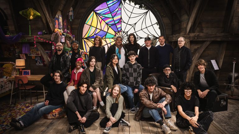 Image from the Wednesday season 2 table read on the Wednesday set: (L to R) Georgie Farmer, Victor Dorobantu, Luyanda Unati Lewis-Nayo, Joy Sunday, Owen Painter, Emma Myers, Billie Piper, Jenna Ortega, Evie Templeton, Luis Guzmán, Isaac Ordonez, Catherine Zeta-Jones, Alfred Gough, Noah Taylor, Miles Millar, Tim Burton, Steve Buscemi, Moosa Mostafa, Hunter Doohan on the set of Wednesday season 2. Cr. Helen Sloan/Netflix © 2024