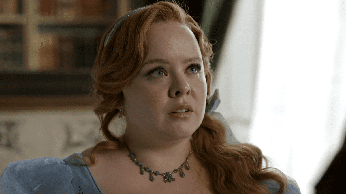 Nicola Coughlan looking up in concern during Bridgerton Season 3 in baby blue dress