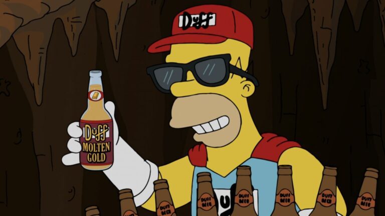 Homer Simpson dressed as Duff Man wearing a Duff hat and costume while holding a Duff Molten Gold bottle on The Simpsons.