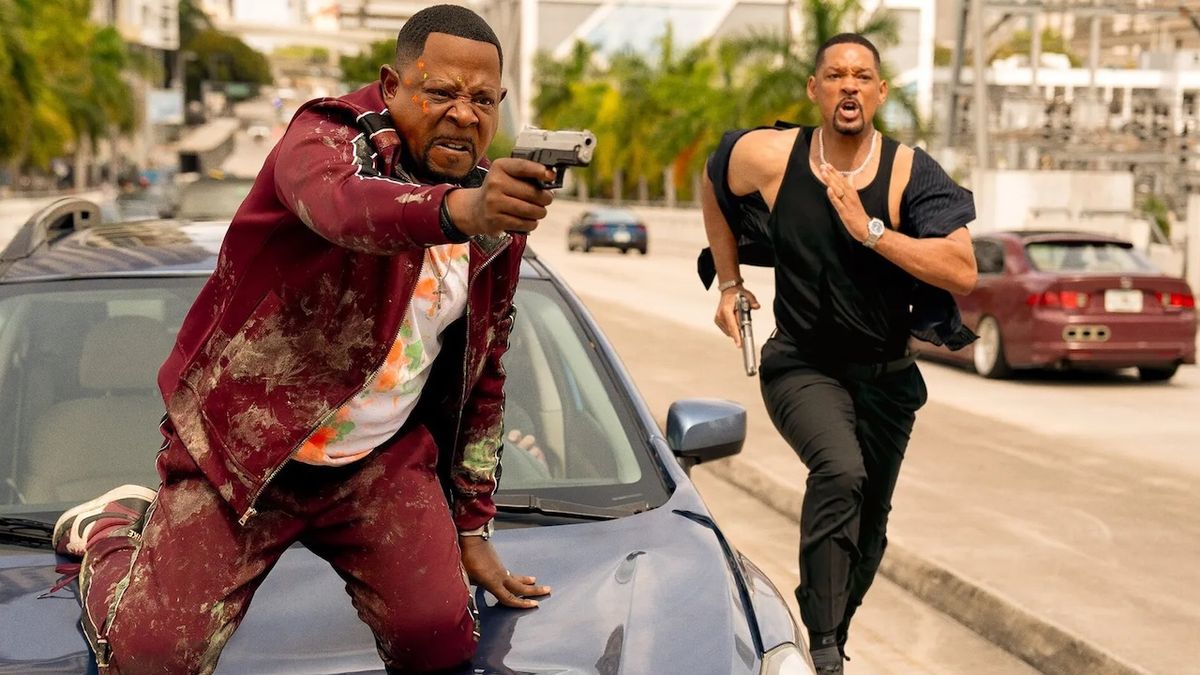 Martin Lawrence with gun on car and Will Smith running in Bad Boys: Ride or Die still 