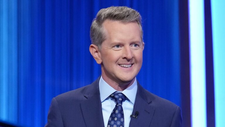 Ken Jennings in navy jacket hosting Celebrity Jeopardy