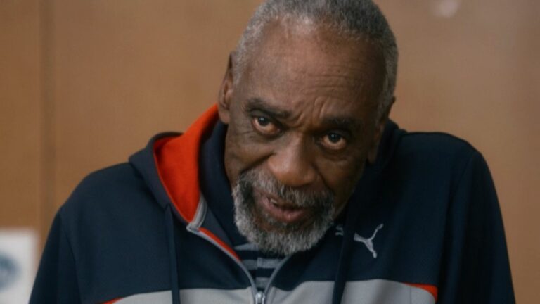 Bill Cobbs wearing a track suit while standing in conversation in Night At The Museum: Secret of the Tomb.