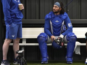 Payton Henry, receveur des Blue Jays de Toronto, à droite, est assis dans l'enclos des releveurs lors d'un entraînement de baseball de printemps, le 18 février 2024, à Dunedin, en Floride.