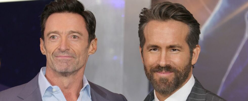 Ryan Reynolds and Hugh Jackman smiling on the red carpet of The Adam Project