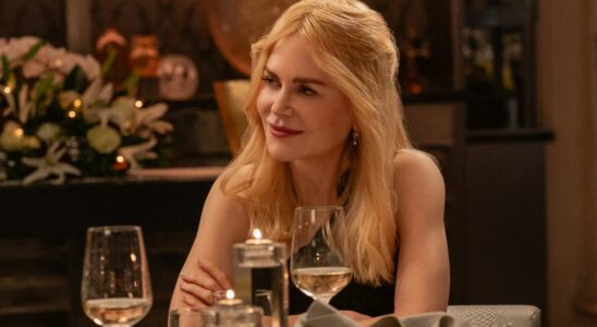 Nicole Kidman sits at a table with a serene smile in A Family Affair.