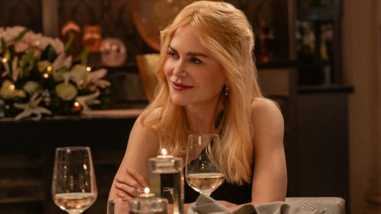 Nicole Kidman sits at a table with a serene smile in A Family Affair.