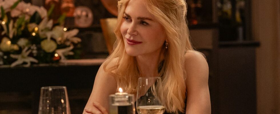 Nicole Kidman sits at a table with a serene smile in A Family Affair.