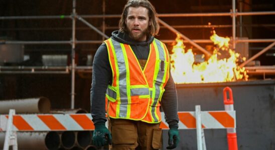 Max Thieriot as Bode standing in front of a fire wearing a construction vest in the Season 2 finale of Fire Country.