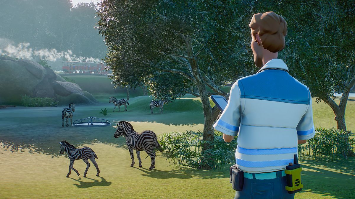 un gardien de zoo surveille les zèbres dans Planet Zoo