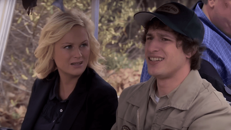 Andy Samberg and Amy Poehler riding in a golf cart in Parks and Recreation