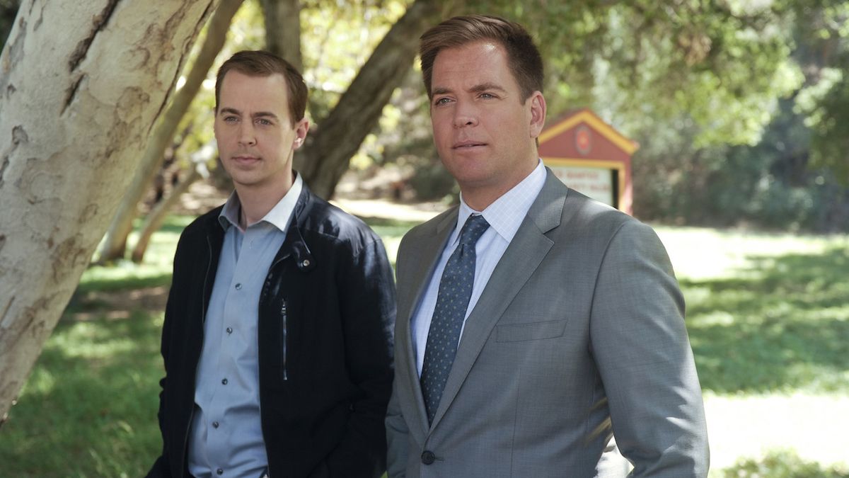 Sean Murray and Michael Weatherly standing underneath tree in NCIS episode