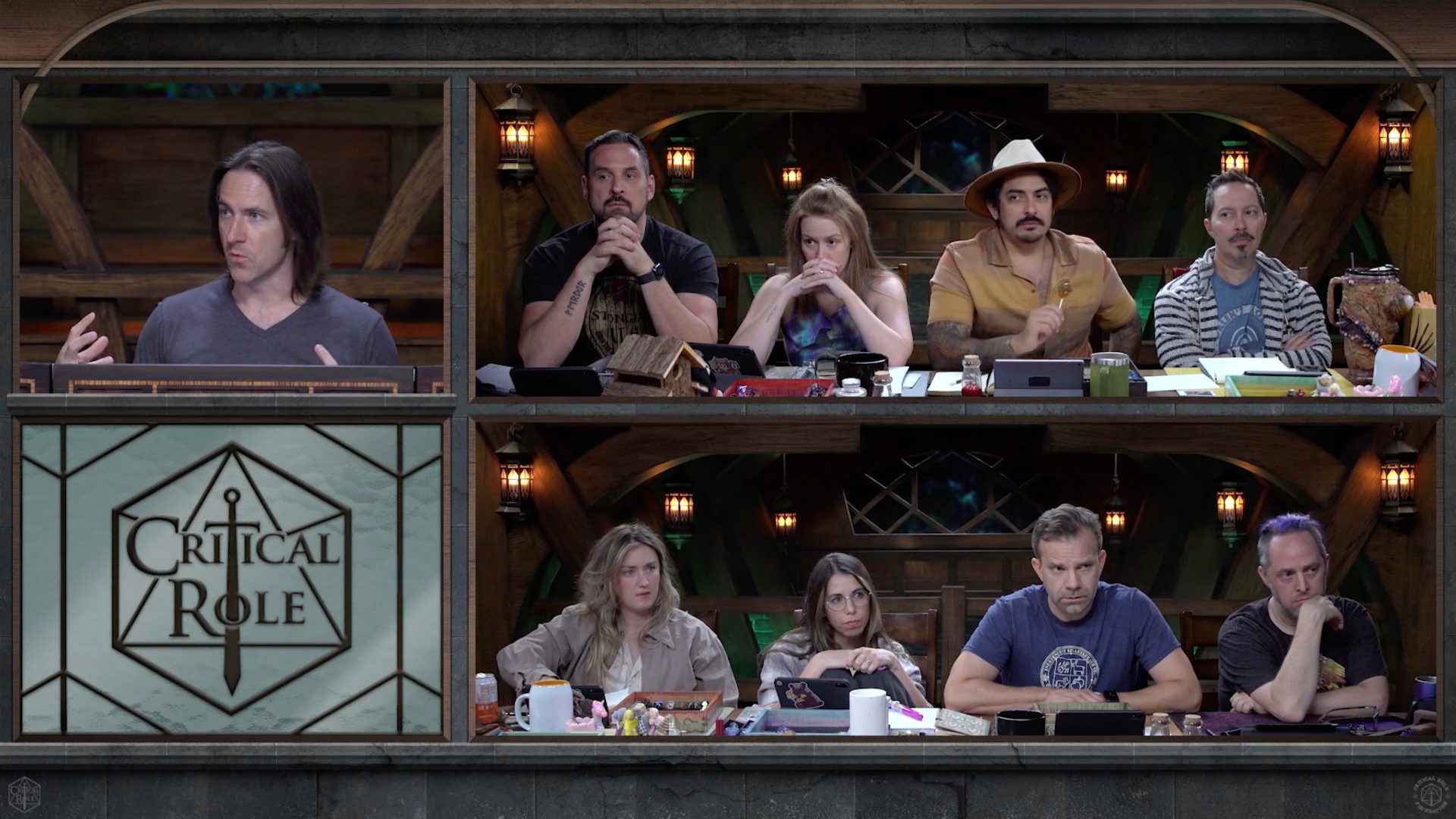 The cast of Critical Role sit around a table playing Dungeons & Dragons from L-R: Matthew Mercer, Travis Willingham, Marisha Ray, Robbie Daymond, Sam Riegel, Ashley Johnson, Laura Bailey, Liam O'Brien, and Taliesin Jaffe