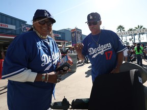 Les fans posent avec leur bobblehead Shohei Ohtani avant le match contre les Orioles de Baltimore au Dodger Stadium le 28 août 2024 à Los Angeles.