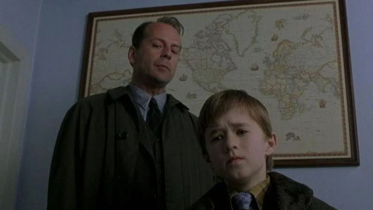 Malcolm Crowe (Bruce Willis) and Cole Sear (Haley Joel Osment) look at something ominously in The Sixth Sense