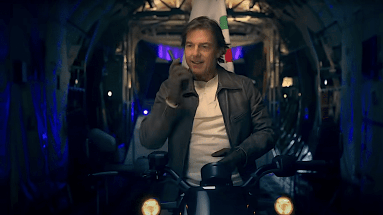 Tom Cruise riding motorcycle on a plane with Olympics flag during 2024 Paris Olympics Closing Ceremony