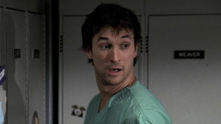 Dr. Carter standing at his locker in ER Season 12