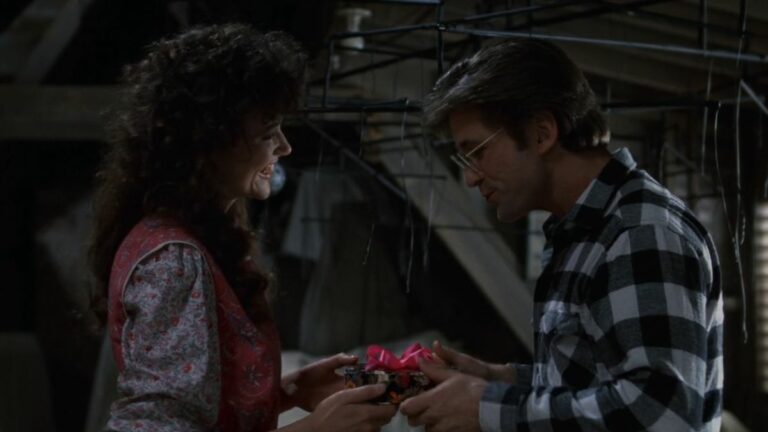 Geena Davis giving Alec Baldwin a gift in Beetlejuice